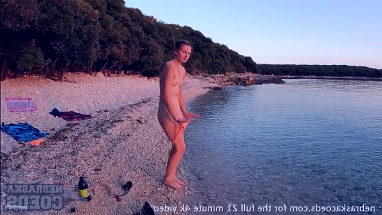 nude fire dancing on the beach at sunset